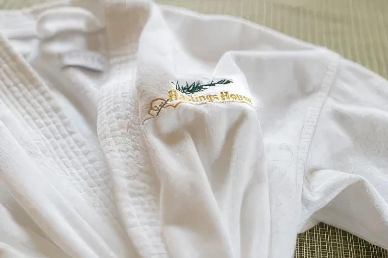 Crisp white bathrobes embroidered with the property's signature crest await guests, embodying the refined luxury that defines this Salt Spring Island retreat.