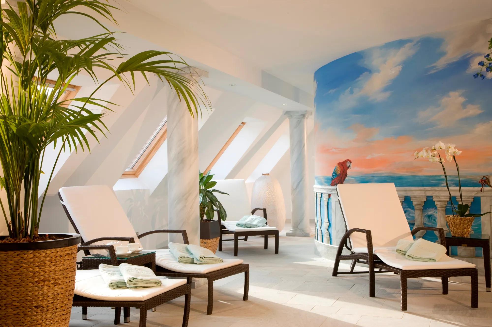 Skylights bathe wicker loungers in golden light while tropical murals transport guests to distant shores in this dreamy attic wellness sanctuary.