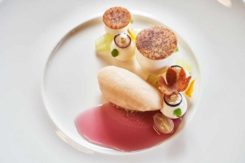 Artfully plated dessert showcases the resort's culinary finesse with delicate soufflés, berry coulis, and edible flowers creating an Instagram-worthy finale to dinner.