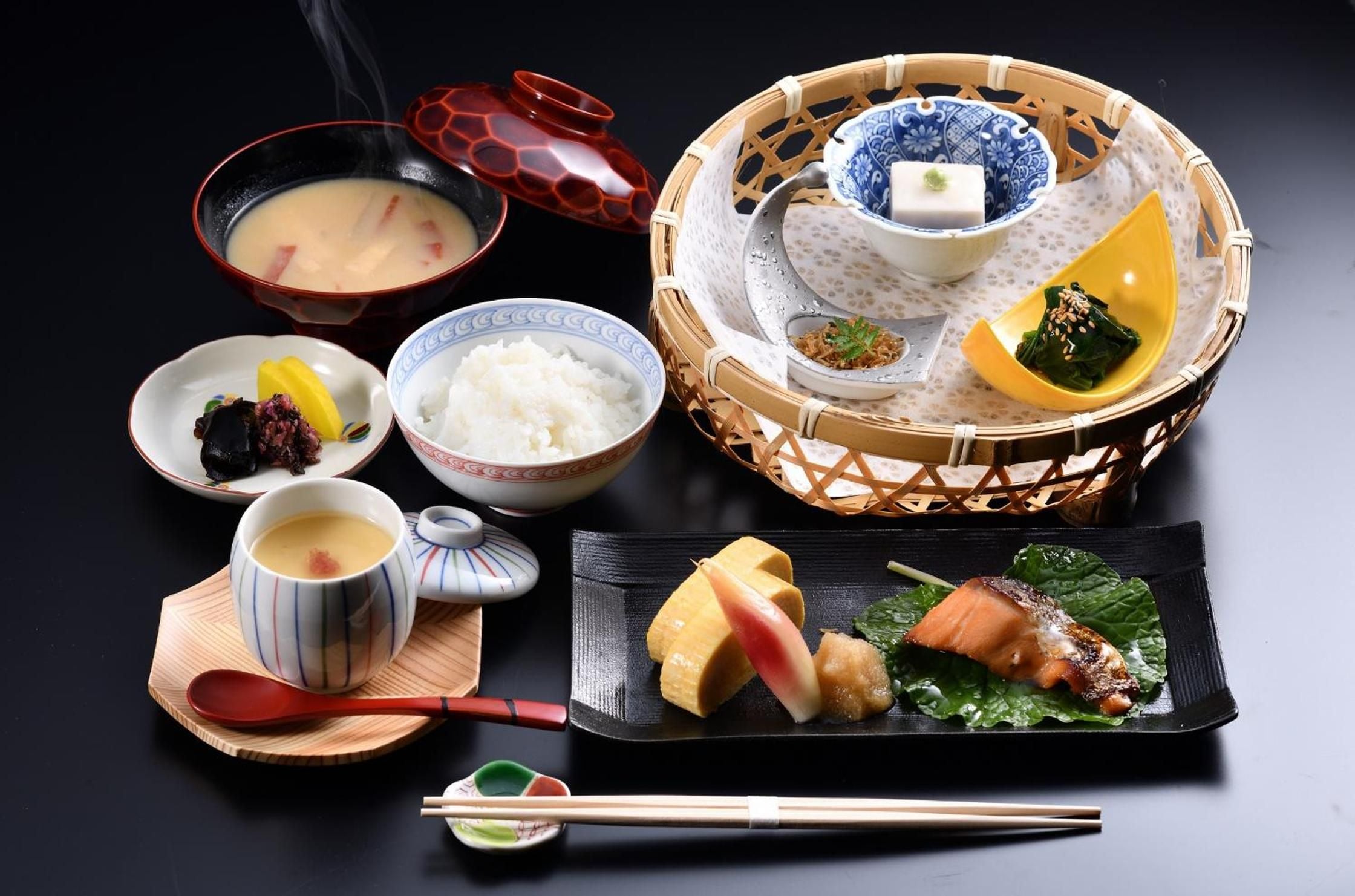 Exquisite kaiseki presentation showcases seasonal artistry in lacquered bowls and bamboo vessels, each delicate morsel reflecting centuries of culinary tradition and meticulous craftsmanship.