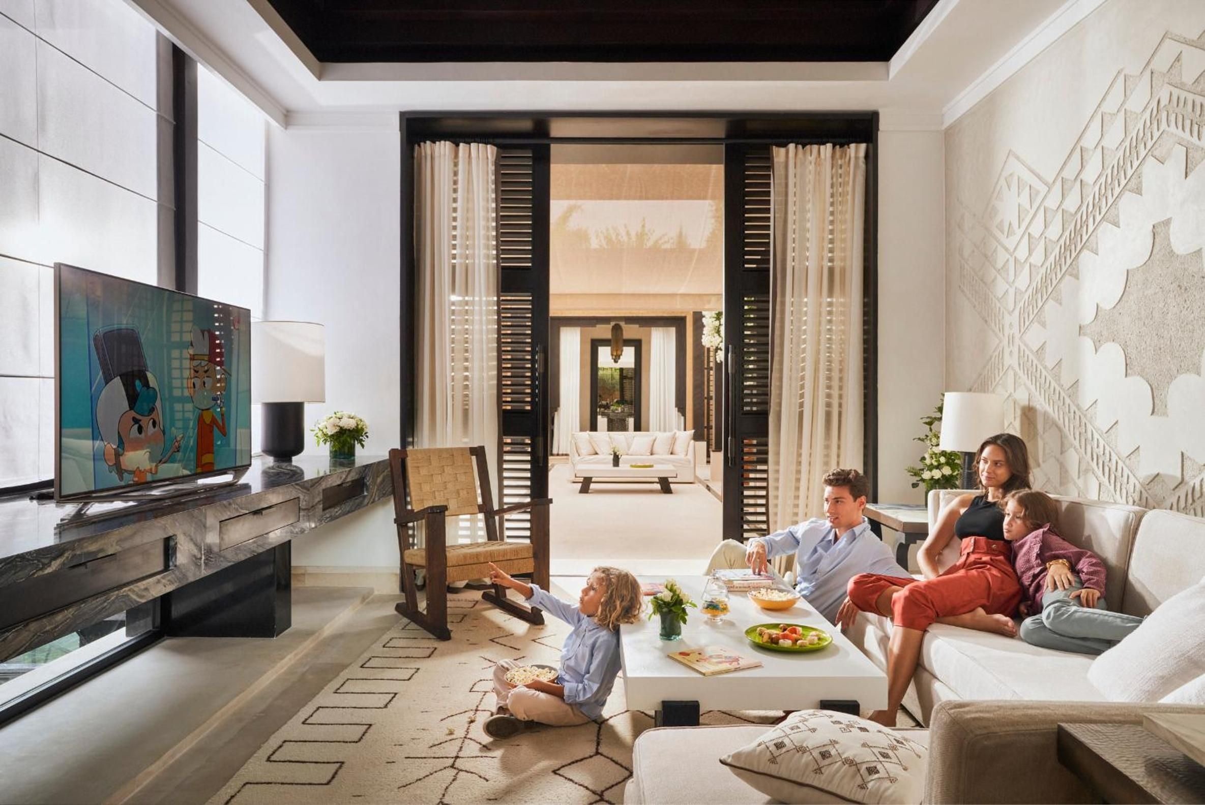Families gather in palatial suites where Moroccan craftsmanship meets modern luxury—hand-carved screens, plush seating, and soaring ceilings create intimate moments amid grandeur.