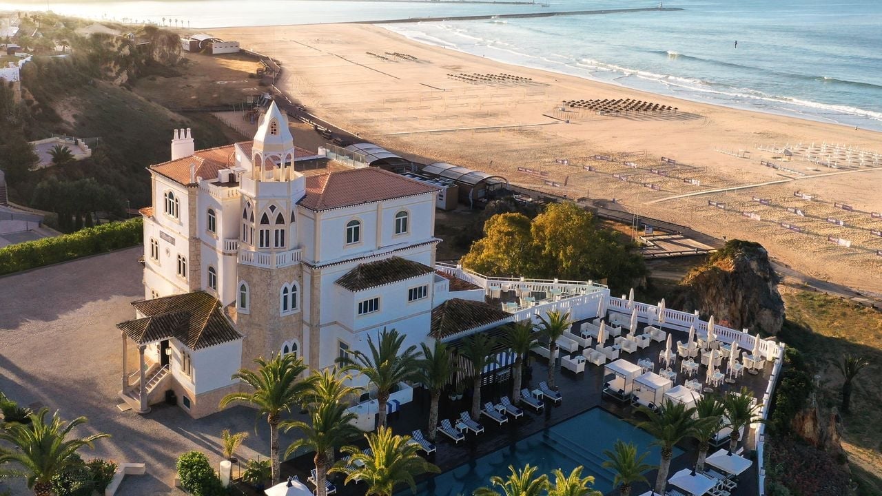 Moorish-inspired architecture rises dramatically above golden sands, where terracotta tiles and whitewashed walls catch Portugal's honeyed coastal light at this clifftop sanctuary.