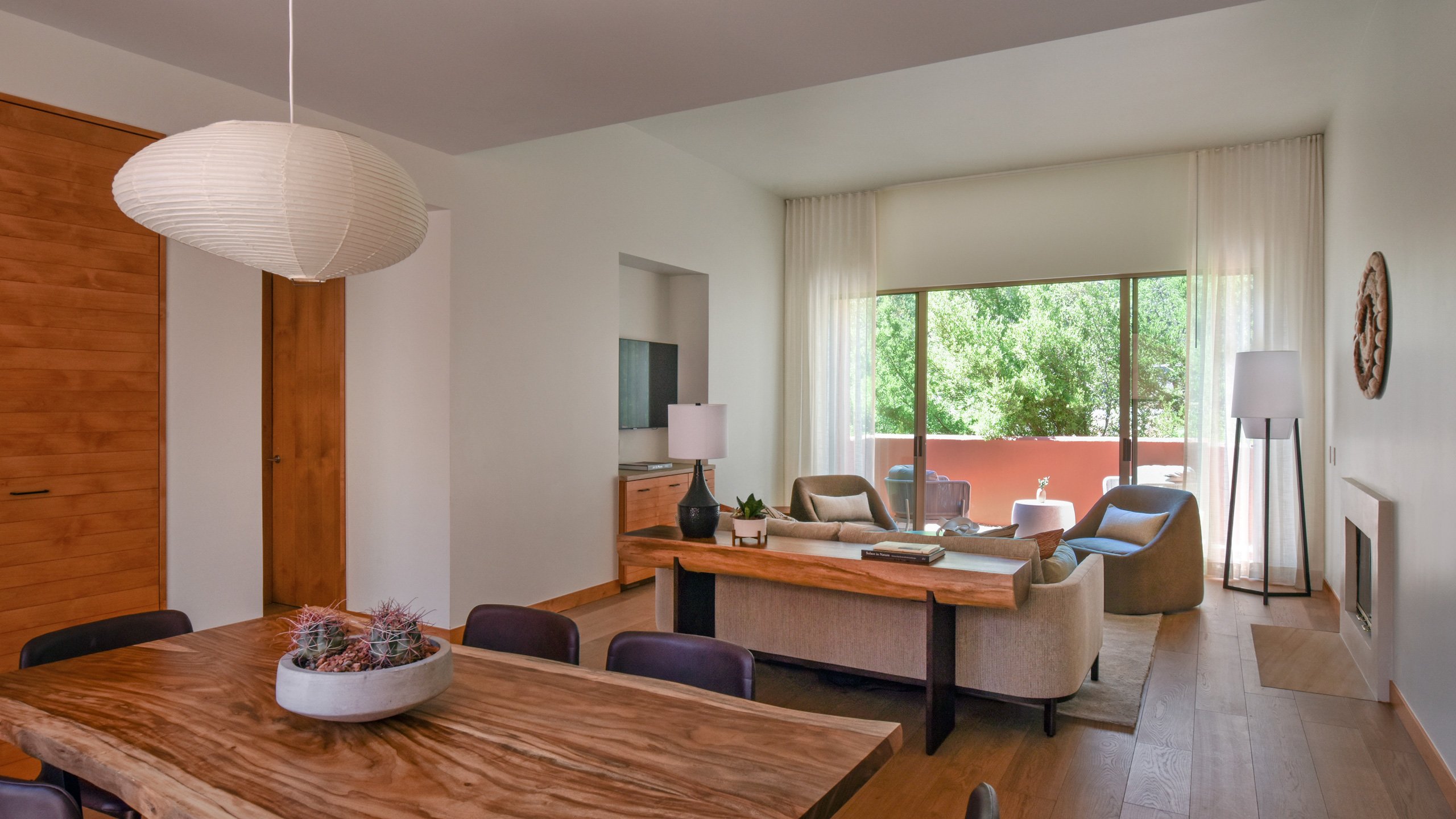 Warm wood tones and desert hues create a serene sanctuary where handcrafted furnishings and soft natural light invite peaceful contemplation in this thoughtfully designed living space.