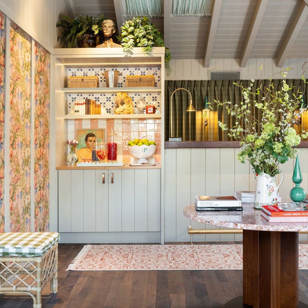 Eclectic charm defines this inviting nook where vintage portraits mingle with fresh botanicals, geometric tiles create visual interest, and thoughtfully curated books invite lingering over morning coffee.