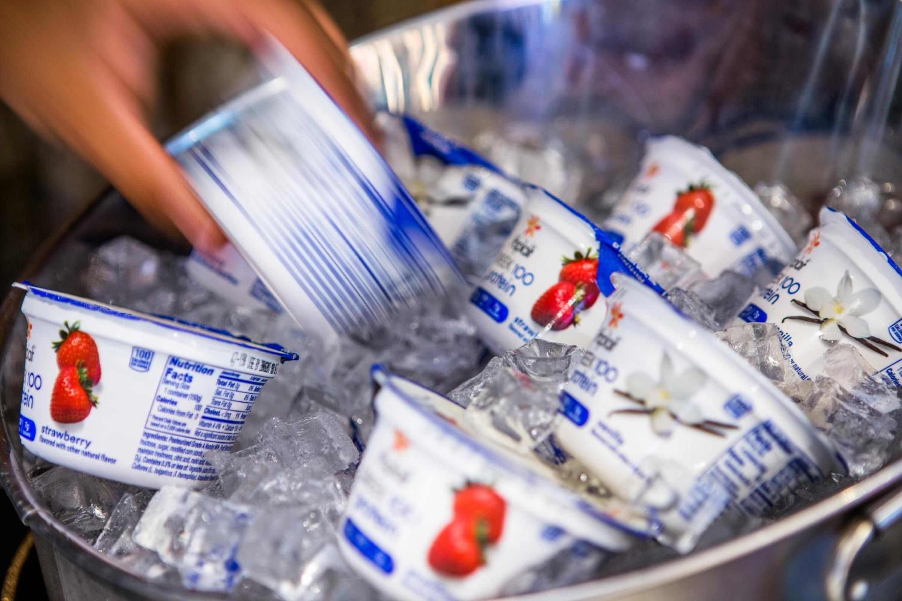 Strawberry yogurt containers nestle in crushed ice, their vibrant red fruit graphics promising fresh flavors at this music-inspired Boston boutique's breakfast spread.