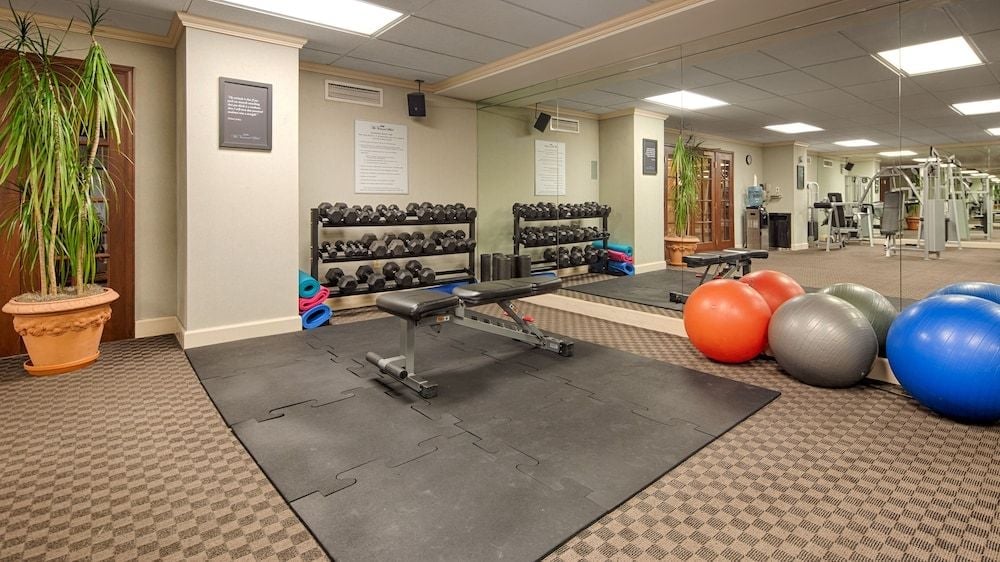 State-of-the-art equipment and vibrant exercise balls create an inviting fitness sanctuary beneath warm lighting, where guests can maintain their wellness routines in comfortable style.
