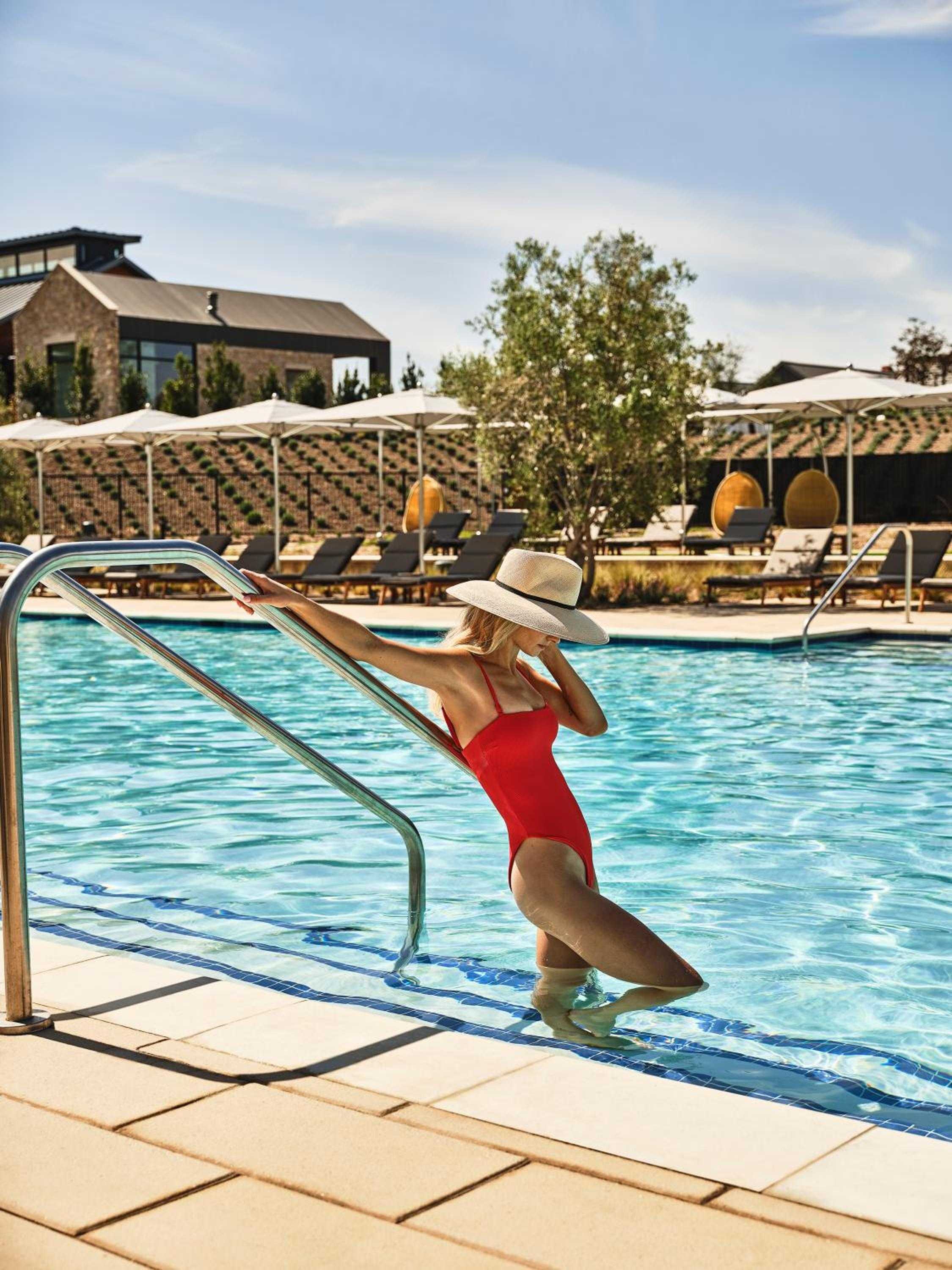 Sun-dappled waters beckon beneath Napa Valley's endless sky, where poolside lounging feels like a California dream complete with vineyard views and golden hour light.