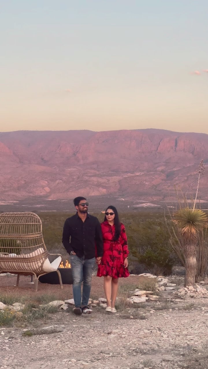 Sunset paints the desert cliffs in rose gold as guests savor the magic hour from their glamping retreat's thoughtfully appointed outdoor sanctuary.