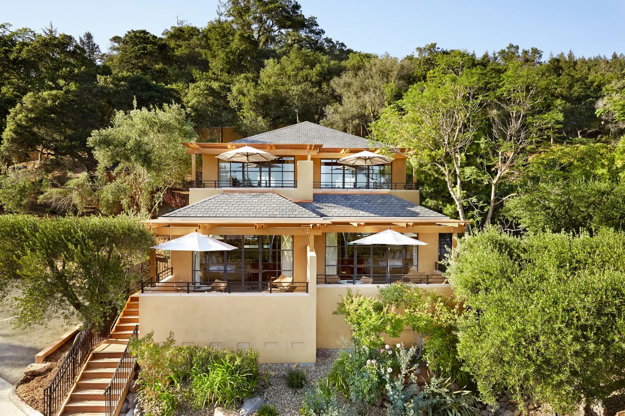 Terraced hillside suites cascade through native oak groves, their warm stucco walls and private patios creating intimate retreats above Napa Valley's golden landscape.