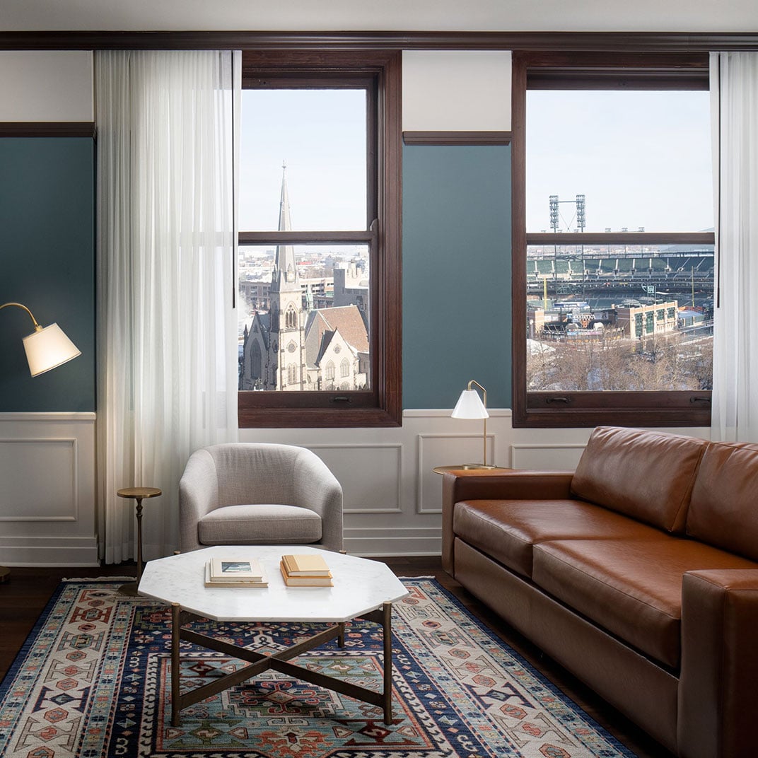 Corner suite windows frame Detroit's cathedral spires and Comerica Park, while rich leather and Persian rugs create an intimate retreat high above the Motor City.