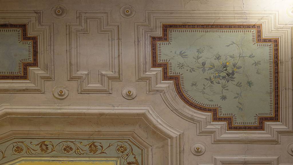 Ornate ceiling frescoes showcase delicate botanical motifs within gilded geometric frames, revealing the property's refined attention to period architectural details and artisanal craftsmanship.