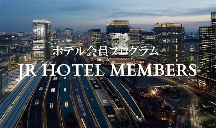 Tokyo's glittering urban canyon spreads beneath twilight skies, where the historic railway station meets soaring glass towers in Japan's pulsing capital.