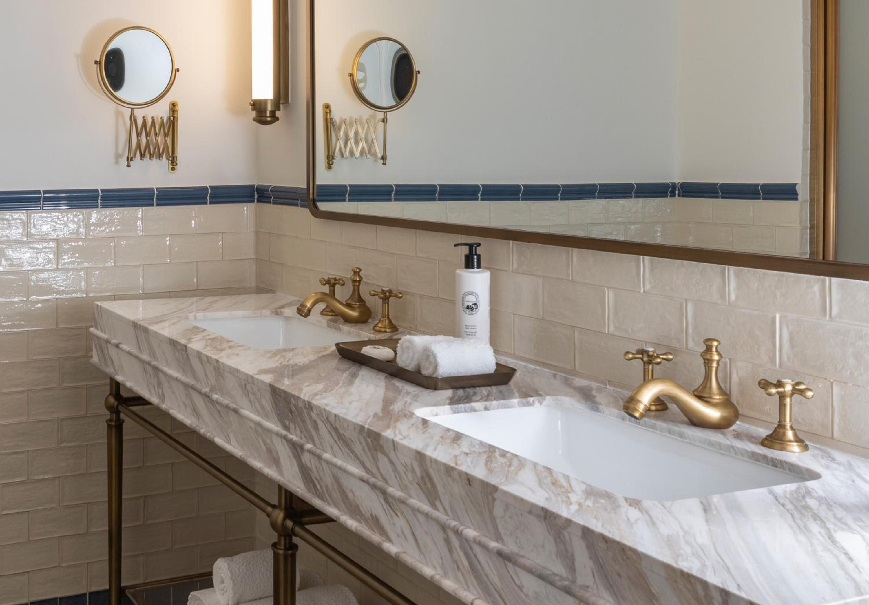 Brass fixtures and Calacatta marble create an elegant vanity moment, where vintage-inspired faucets and extendable mirrors nod to Panama's colonial heritage with modern luxury.