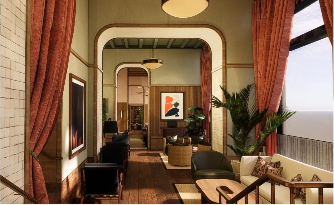 Rust-colored curtains frame intimate seating vignettes where mid-century charm meets contemporary comfort, creating inviting alcoves bathed in warm, golden light throughout the hotel's thoughtfully designed common spaces.