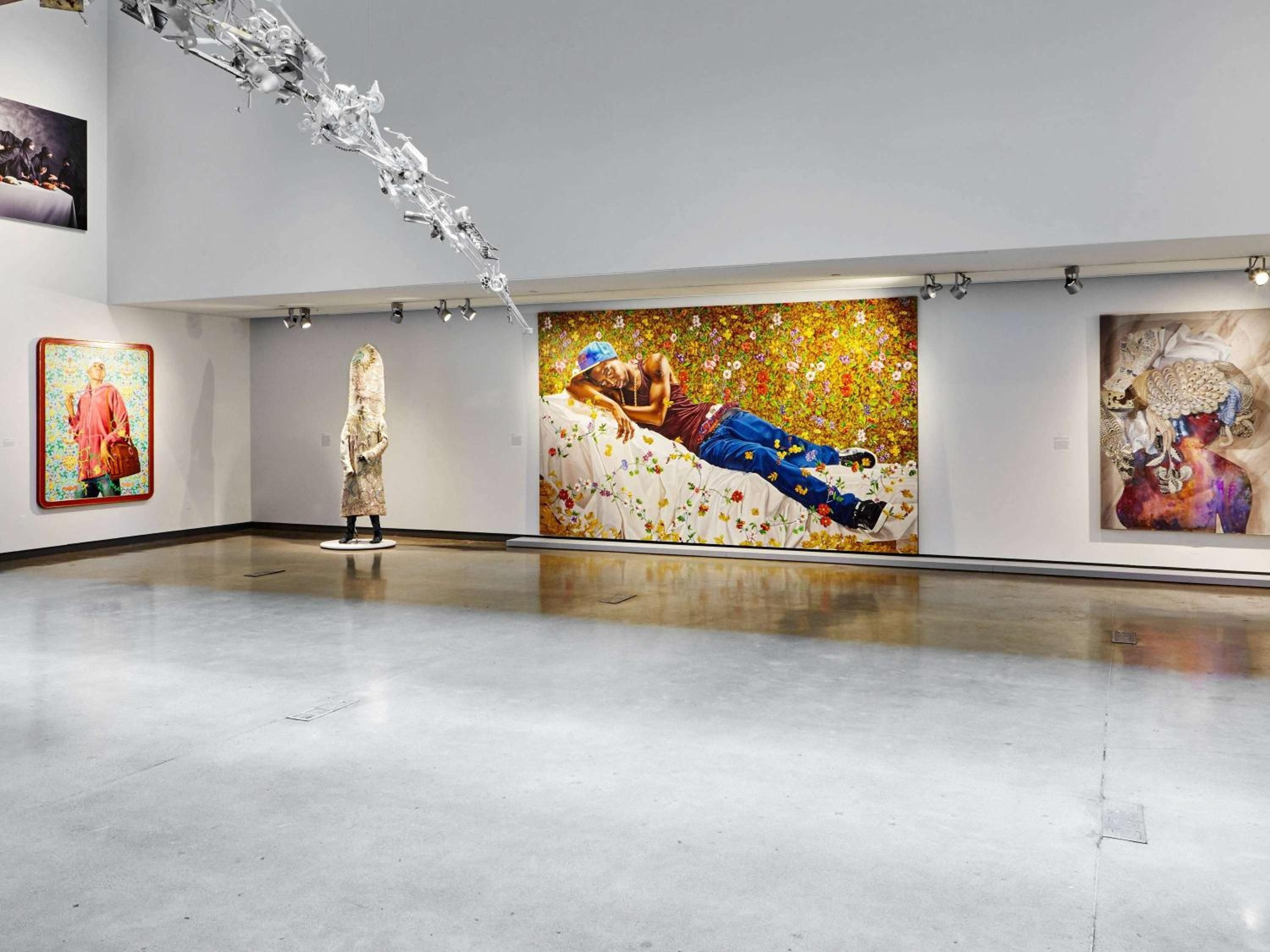 Contemporary art transforms gallery spaces into immersive experiences, where Kehinde Wiley's vibrant portraits command attention alongside sculptural installations beneath dramatic track lighting.