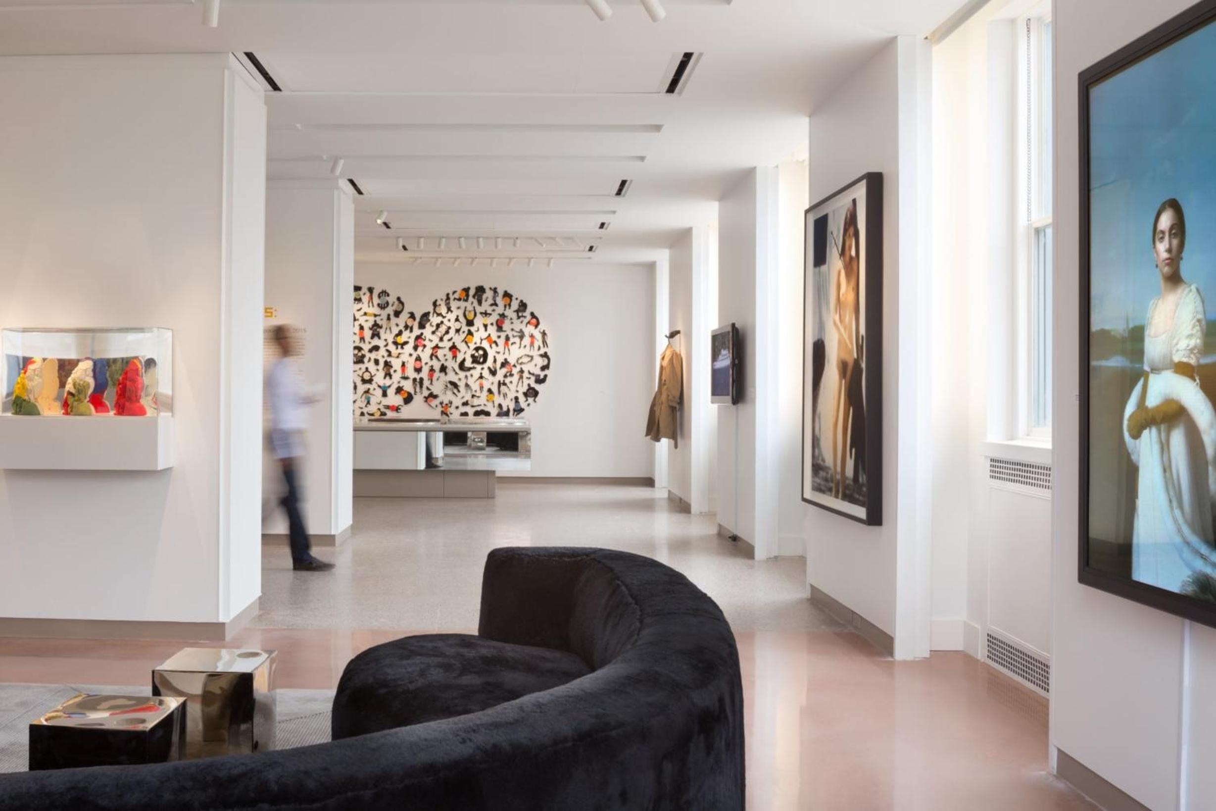 Contemporary art installations and sculptural black seating create an immersive gallery experience where guests can pause between exploring the hotel's rotating exhibitions.