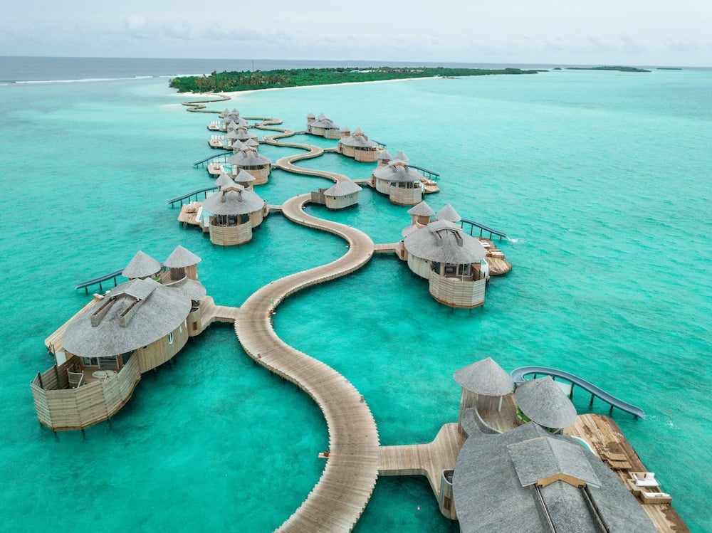 Where the Indian Ocean unfolds from your own water villa rooftop in Medhufaru, MV