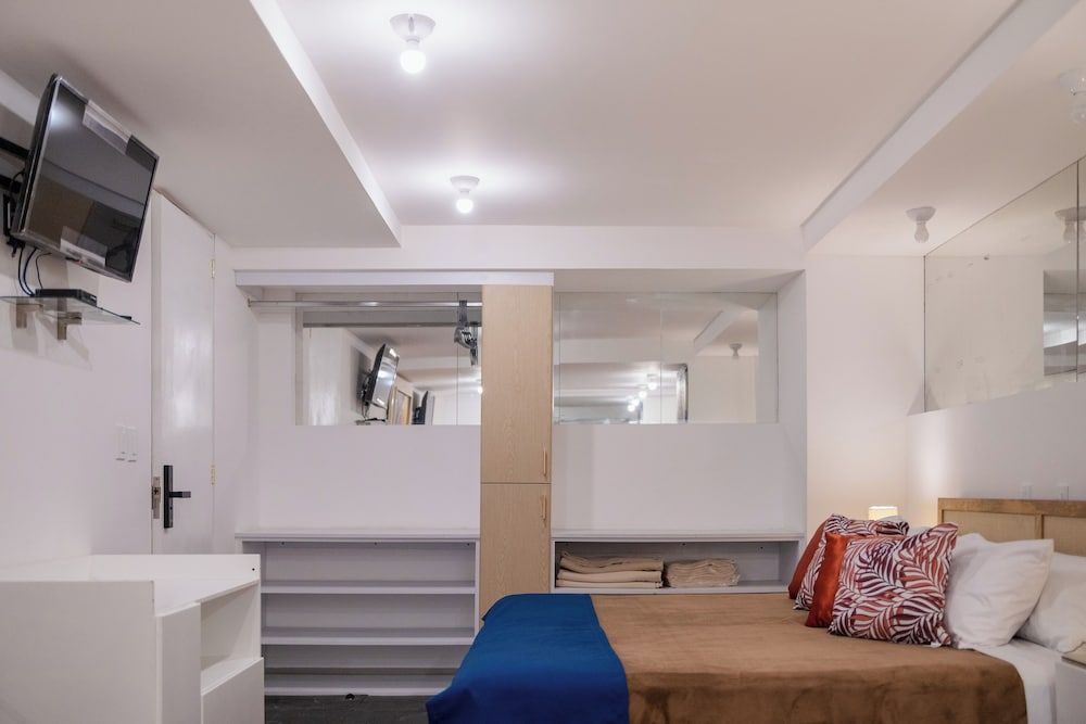 Clever built-in storage and clean lines maximize every inch in this thoughtfully designed cabin-style room, where warm wood accents soften crisp white walls.