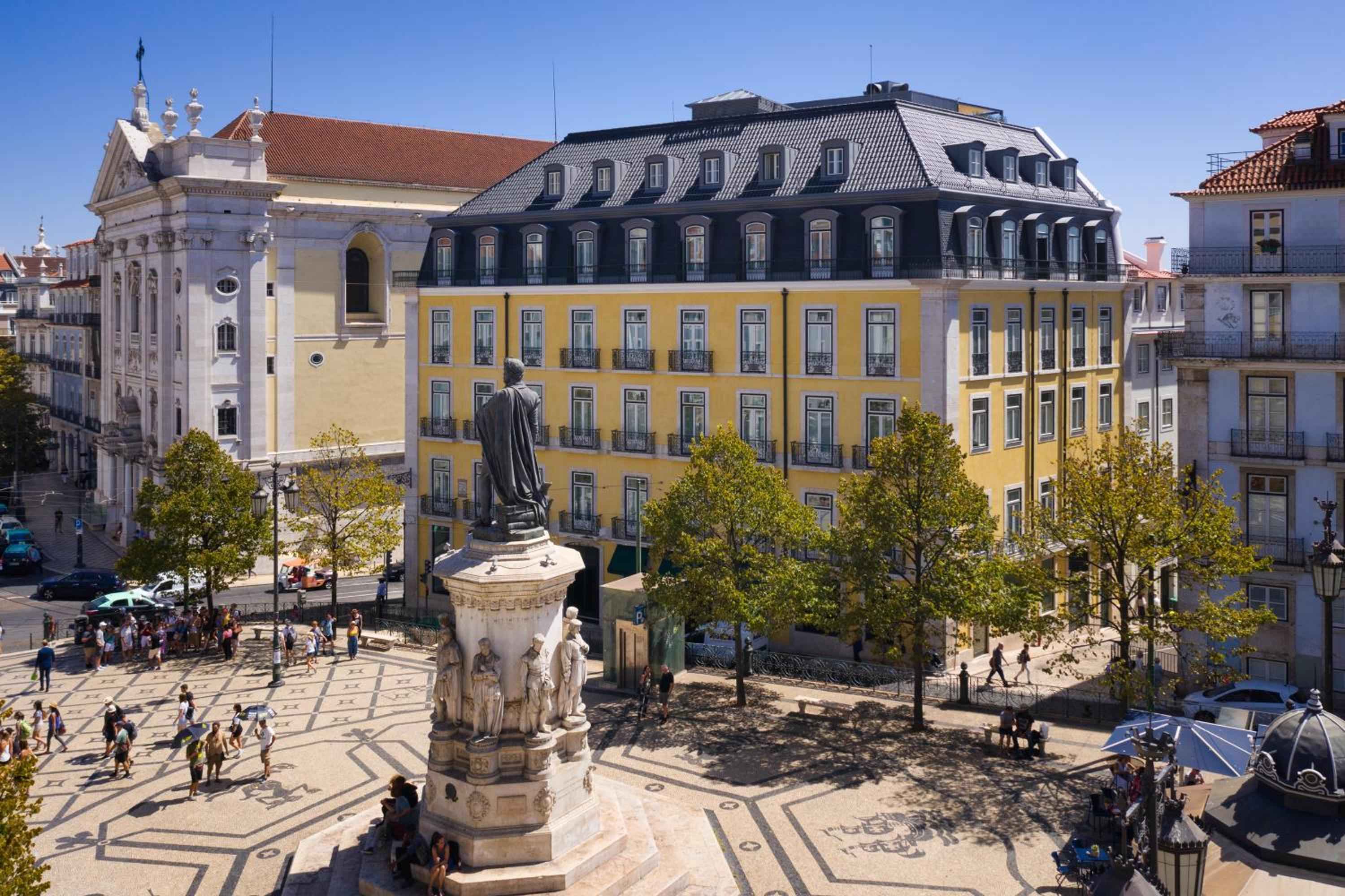 Bright yellow facades and centuries-old stone architecture frame this bustling Lisbon square, where the hotel's prime location puts guests at the heart of Portuguese culture.