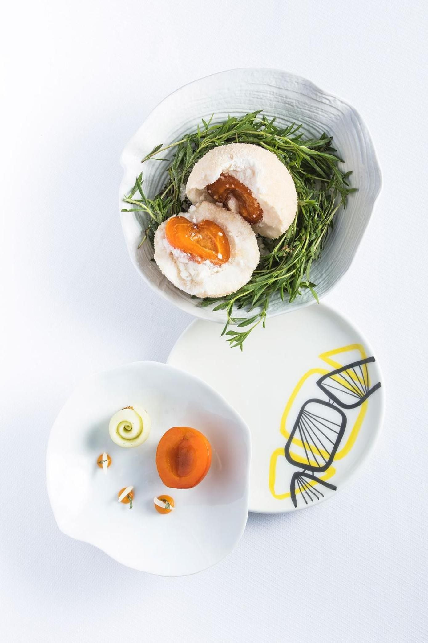 Artfully plated apricot-filled dumplings rest on samphire greens, showcasing the refined culinary artistry that defines this Mediterranean coastal retreat's exceptional dining experience.