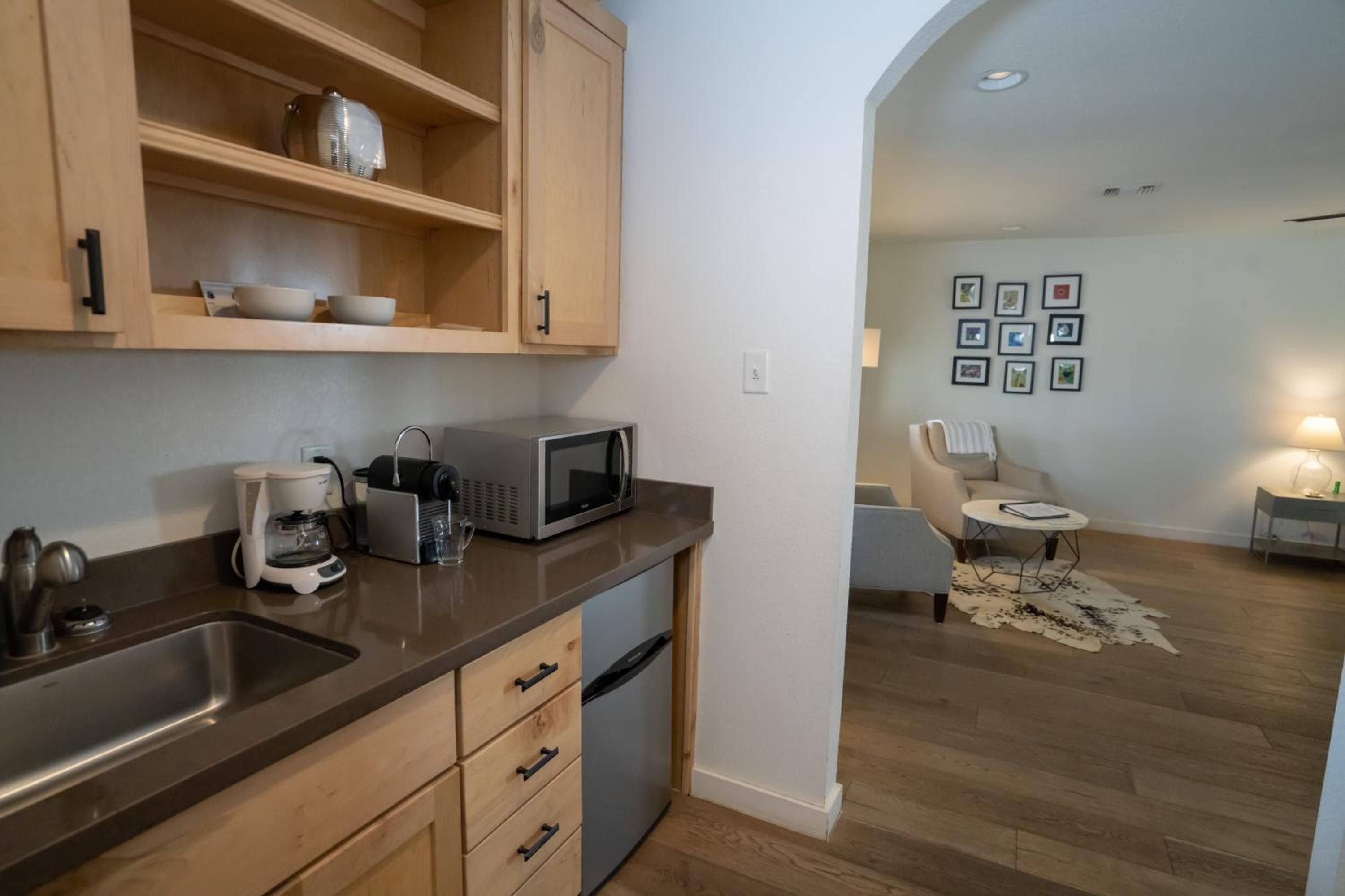 Light-filled kitchenette flows seamlessly into cozy seating areas, where honey-toned cabinetry and polished countertops create an intimate home-away-from-home retreat.