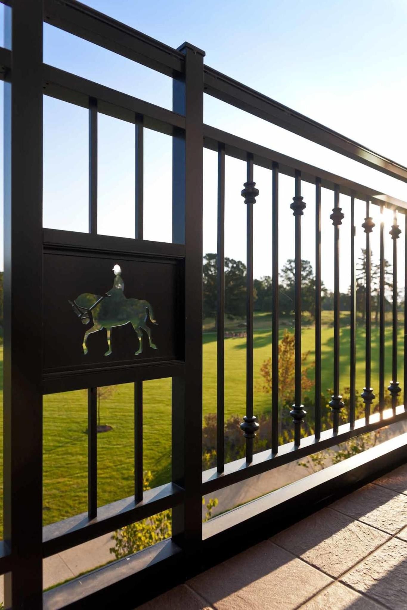 Equestrian-inspired ironwork frames sweeping fairway views from private balconies, where morning light filters through custom railings adorned with graceful horse and rider silhouettes.