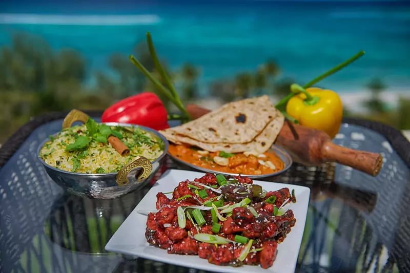 Fresh island flavors come alive with vibrant curries, herb-crusted flatbreads, and glossy glazed meats served oceanside, where tropical breezes enhance every aromatic bite.