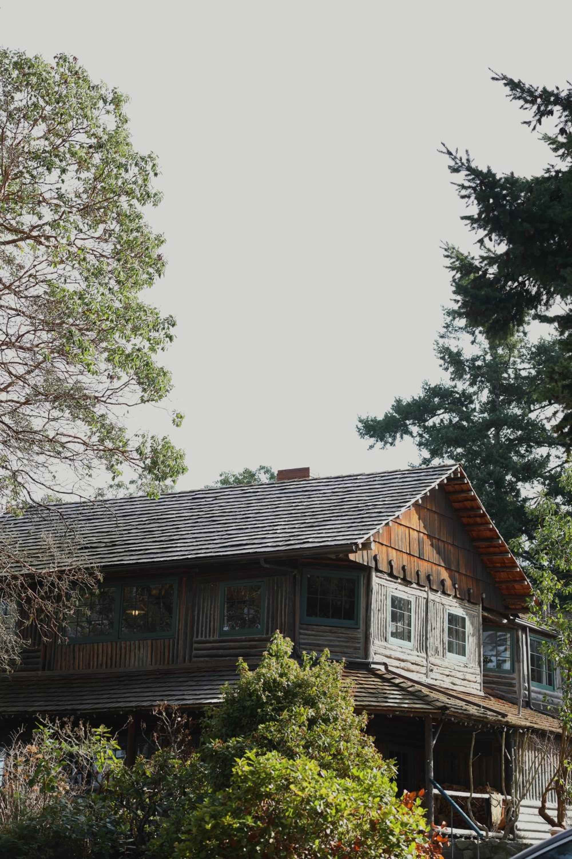 Weathered cedar shingles and vintage windows tell stories of Pacific Northwest maritime history at this beloved waterfront inn, where rustic charm meets timeless hospitality.