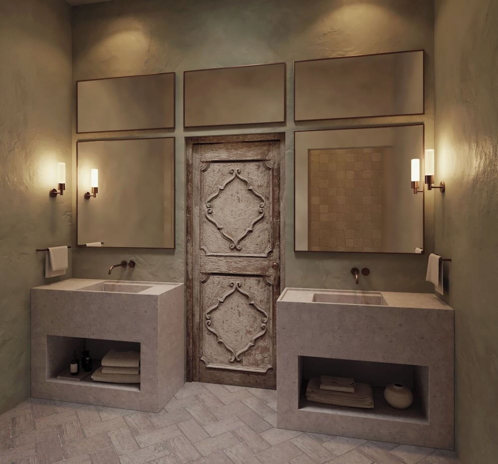 Floating concrete vanities and weathered antique doors create an artful tension between modern minimalism and rustic heritage in this masterfully lit bathroom sanctuary.