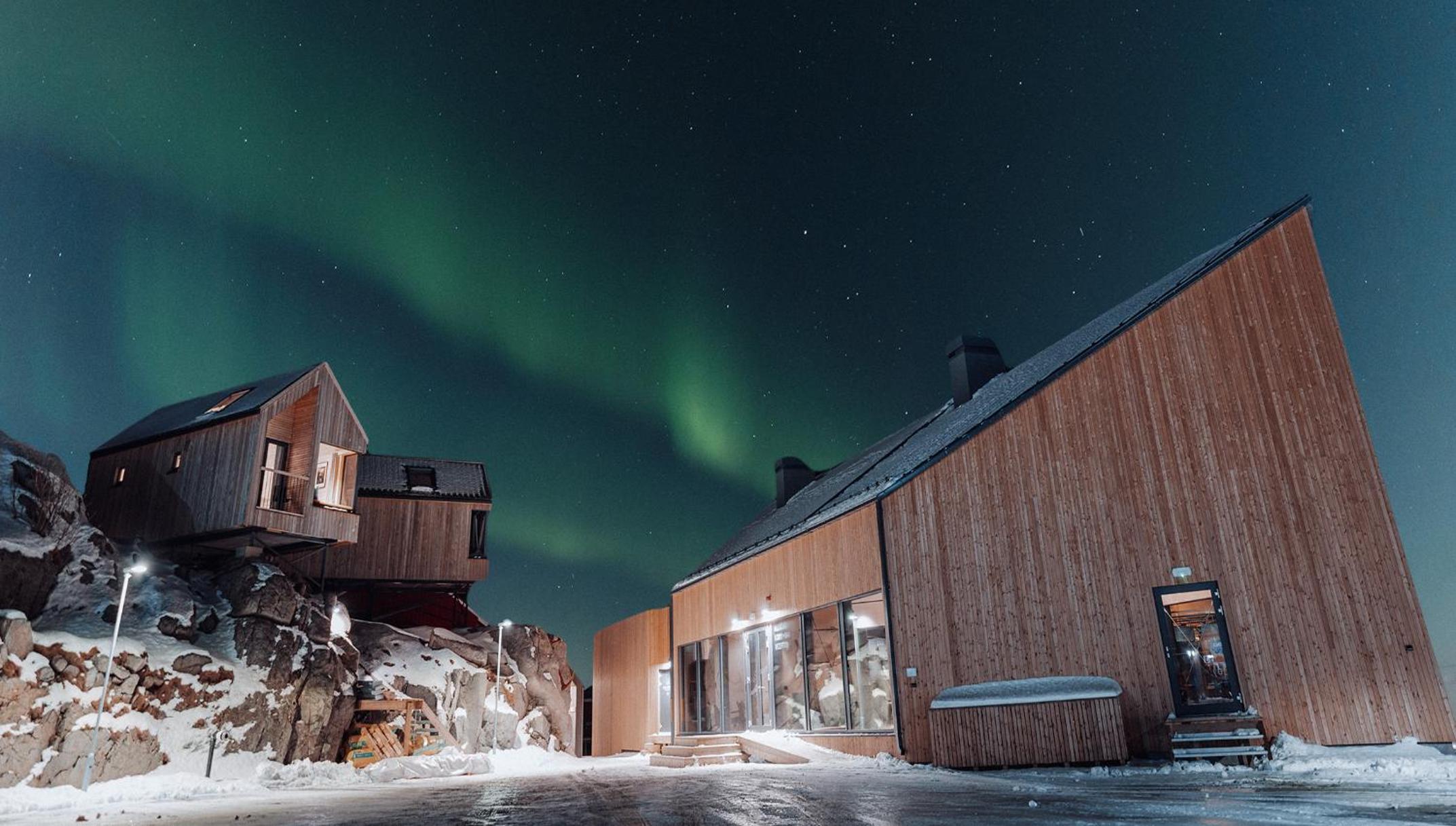 Where the Lofoten coastline meets weathered timber and northern light in Ballstad, Nordland