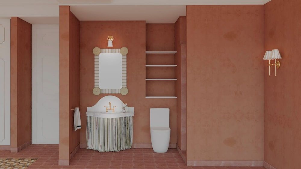 Terracotta walls create an intimate cocoon around the custom vanity, where brass fixtures gleam against handwoven textiles and built-in shelving adds sculptural depth.