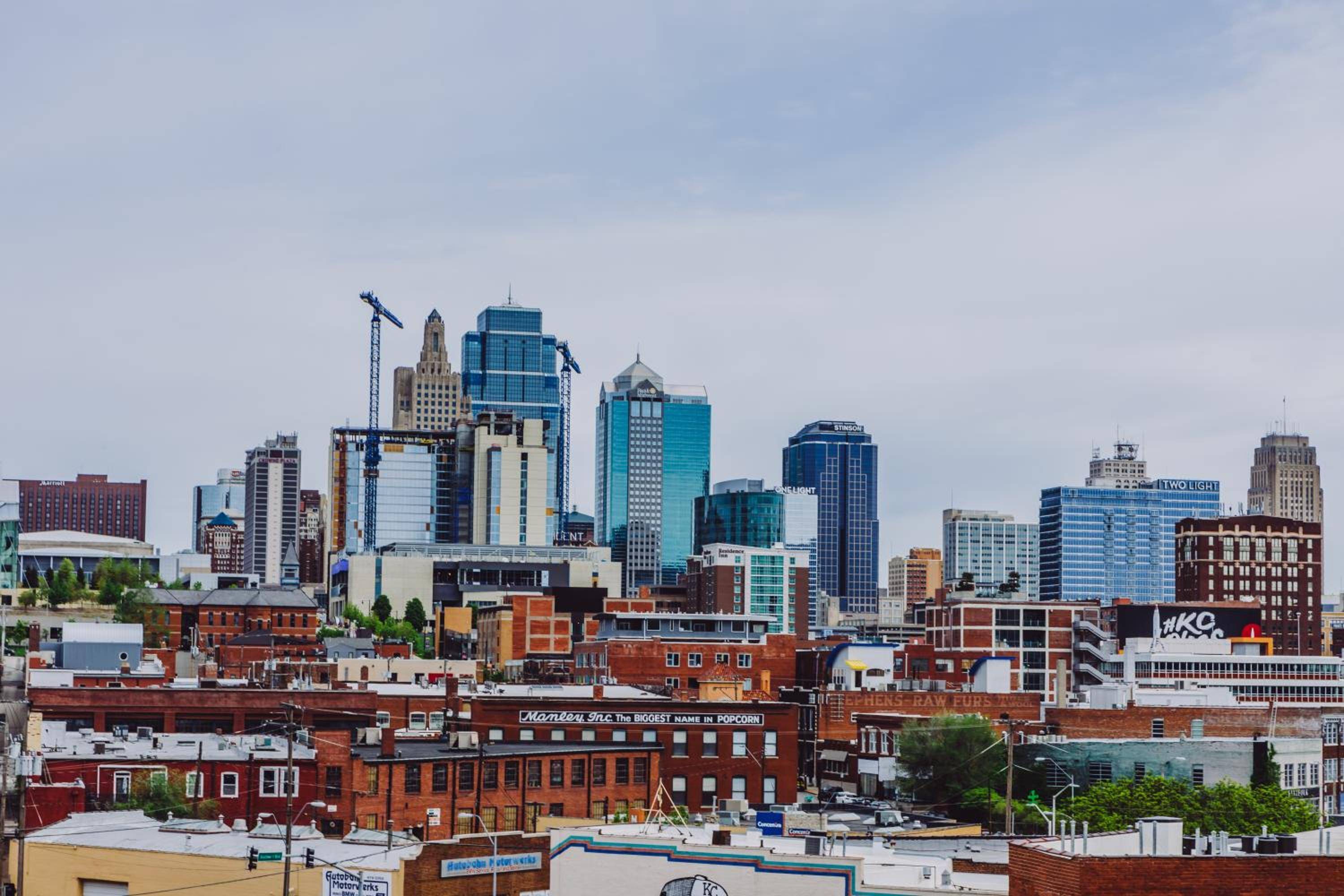 Kansas City's dynamic skyline unfolds beyond the hotel, where historic brick warehouses meet gleaming towers and construction cranes signal the city's evolving energy.