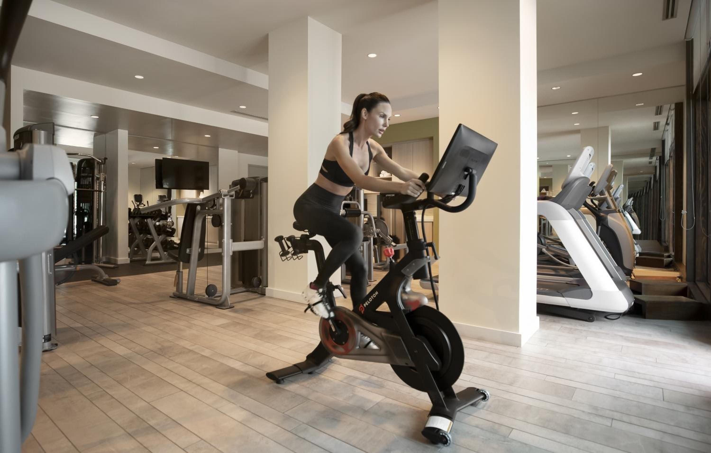 State-of-the-art Peloton bikes anchor the expansive fitness center, where floor-to-ceiling windows and polished wood floors create an inspiring workout sanctuary overlooking Lake Tahoe.