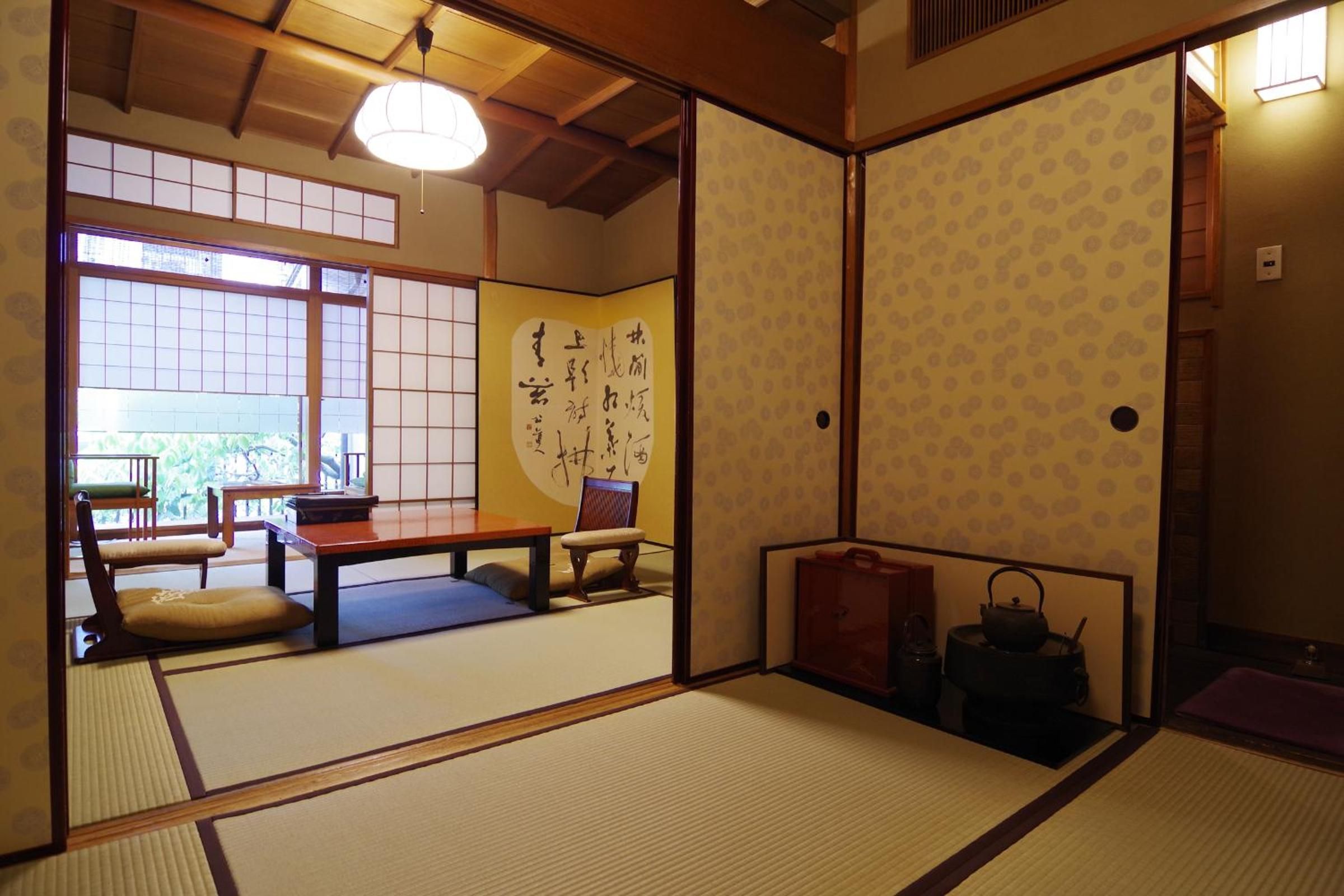 Tatami mats and sliding shoji screens frame intimate spaces where calligraphy scrolls and tea ceremony implements whisper of centuries-old Japanese hospitality traditions.