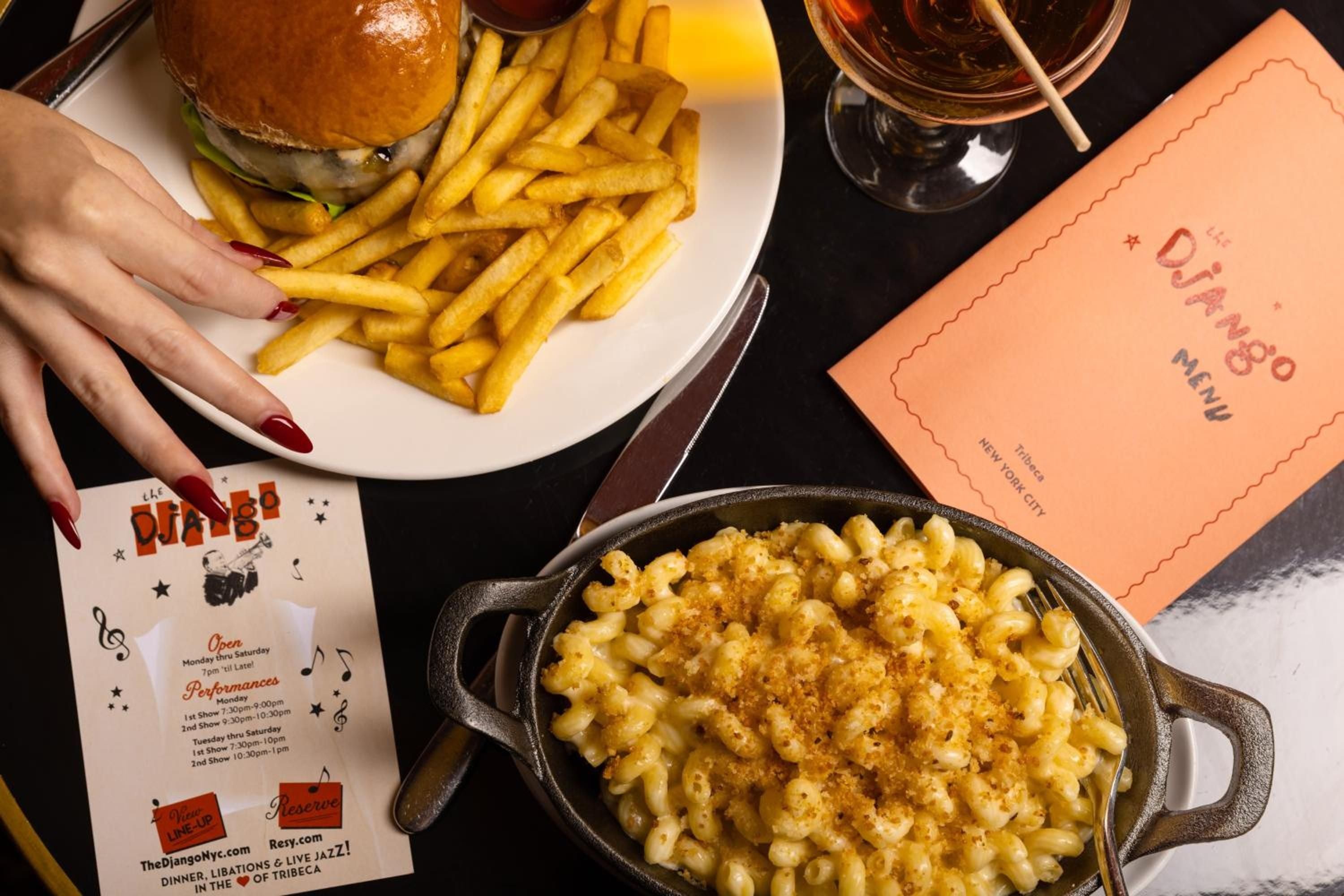 Cast-iron skillets of truffle mac and cheese alongside towering burgers define Django's elevated comfort food, where jazz-age glamour meets modern indulgence.