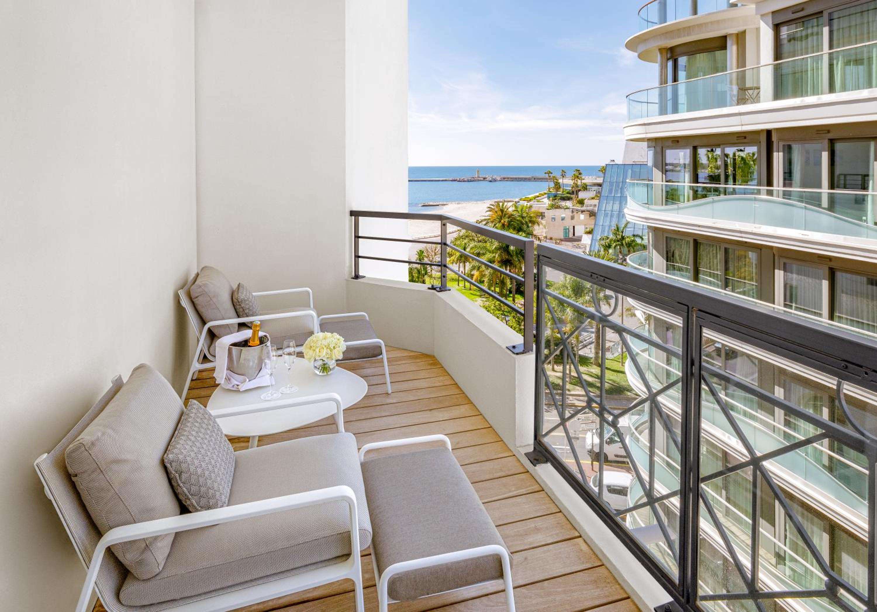 Champagne chills on wood decking as Mediterranean breezes drift across this elevated terrace, where sleek furnishings frame sweeping views of Cannes' glittering coastline.