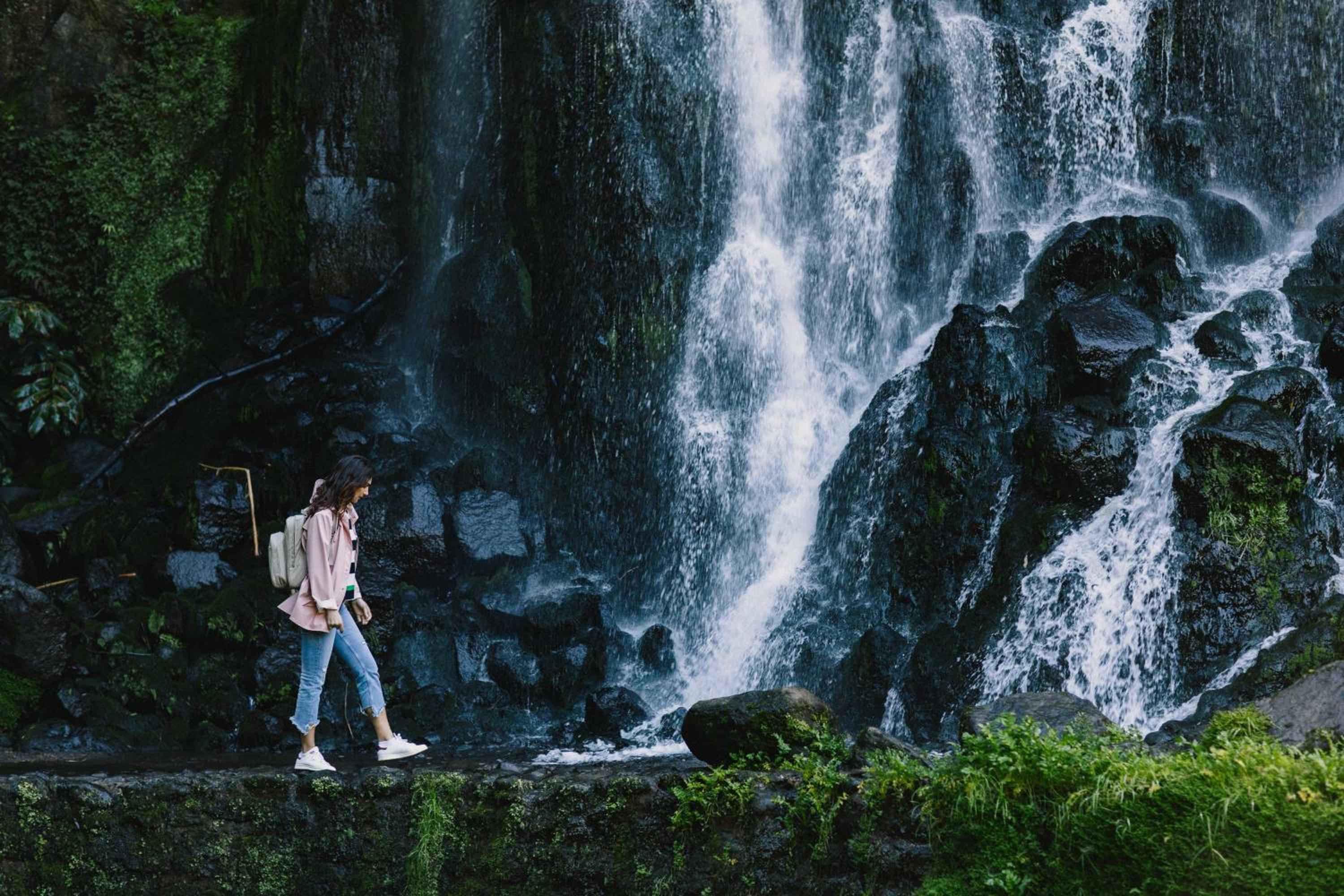 Moss-draped volcanic rocks frame thundering cascades near Octant Furnas, where guests discover the raw beauty of São Miguel's geothermal landscape on guided nature walks.