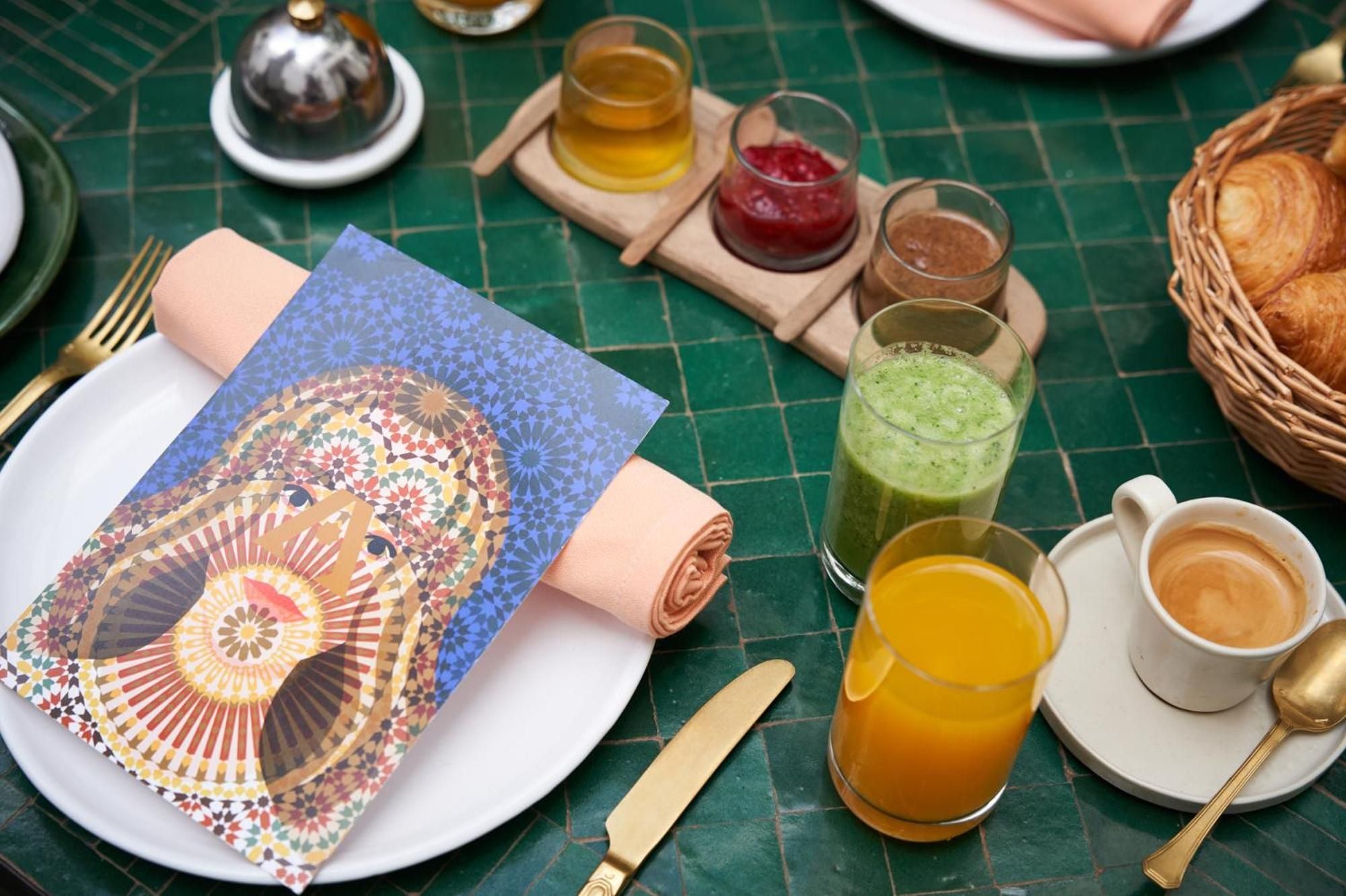 Moroccan-inspired breakfast spreads across emerald tiles, where fresh juices catch morning light and traditional geometric patterns frame a feast of local flavors and artisanal breads.