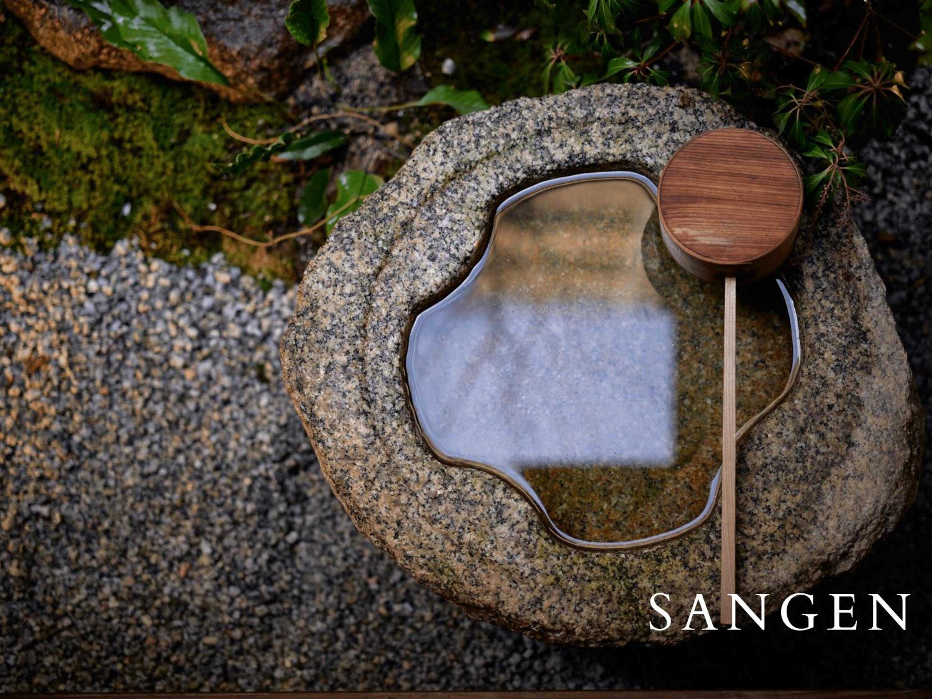 Hand-carved stone basins filled with mineral-rich waters create intimate moments of contemplation, where ancient Japanese bathing rituals meet the artistry of natural design.