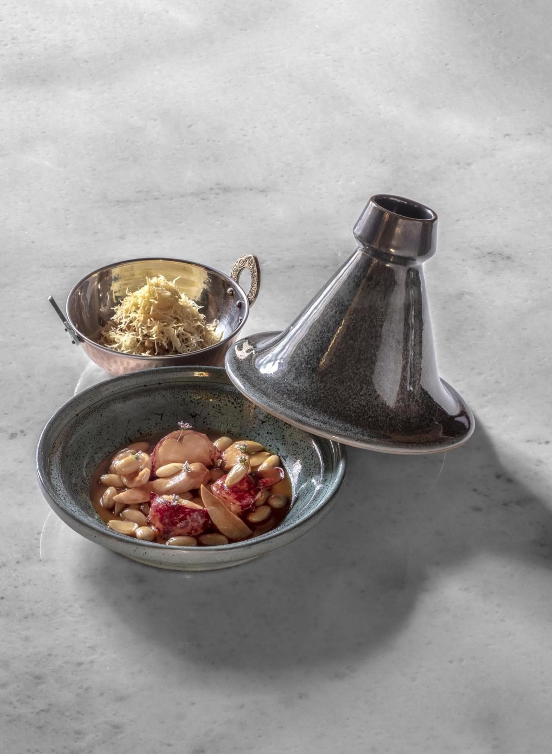 Traditional tagine vessels showcase Morocco's culinary artistry, filled with aromatic ingredients like preserved lemons and almonds that define authentic Marrakech flavors.