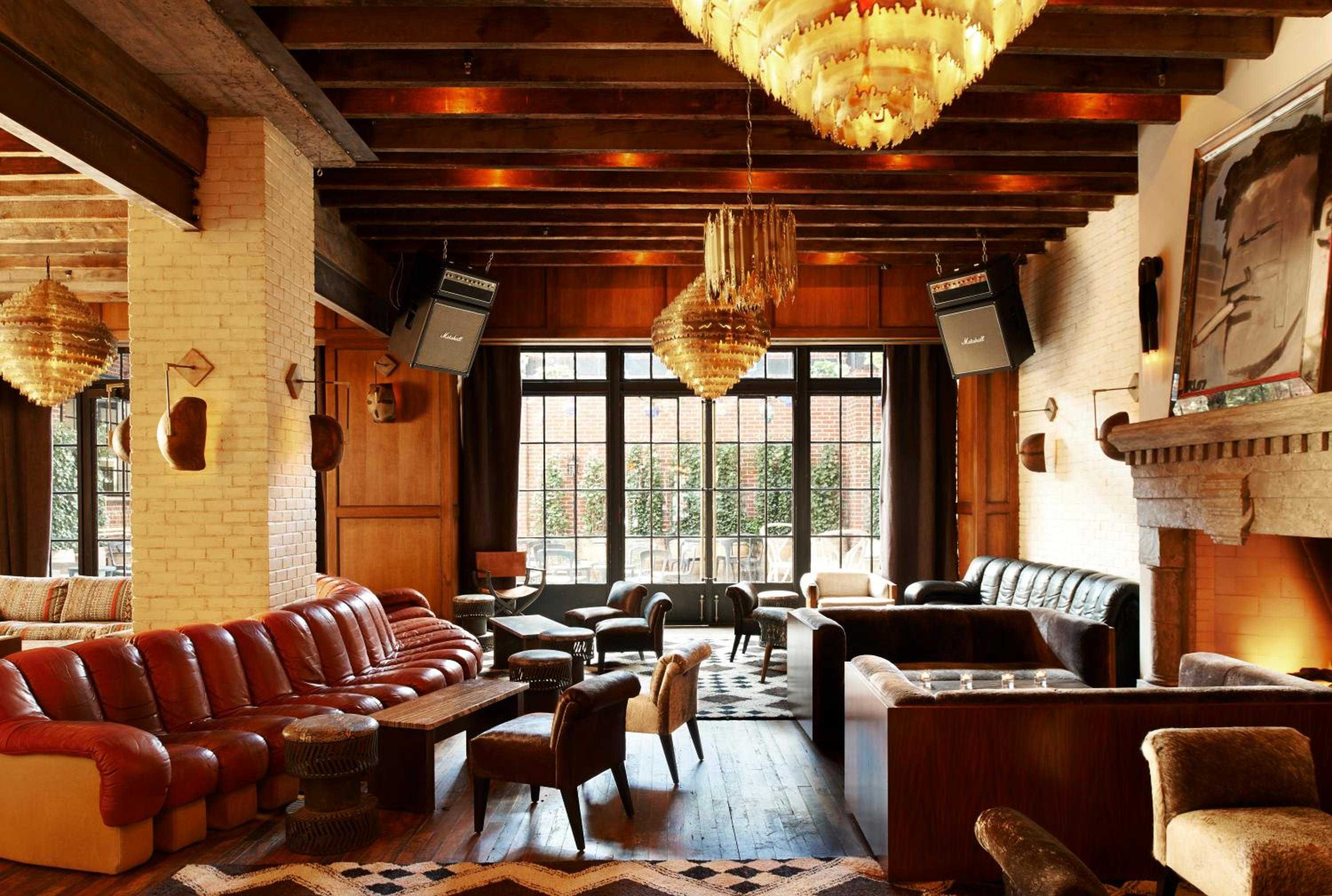 Exposed brick walls and chandeliers create intimate conversation nooks in this sophisticated lounge, where leather banquettes and Marshall amps hint at the hotel's rock-and-roll soul.