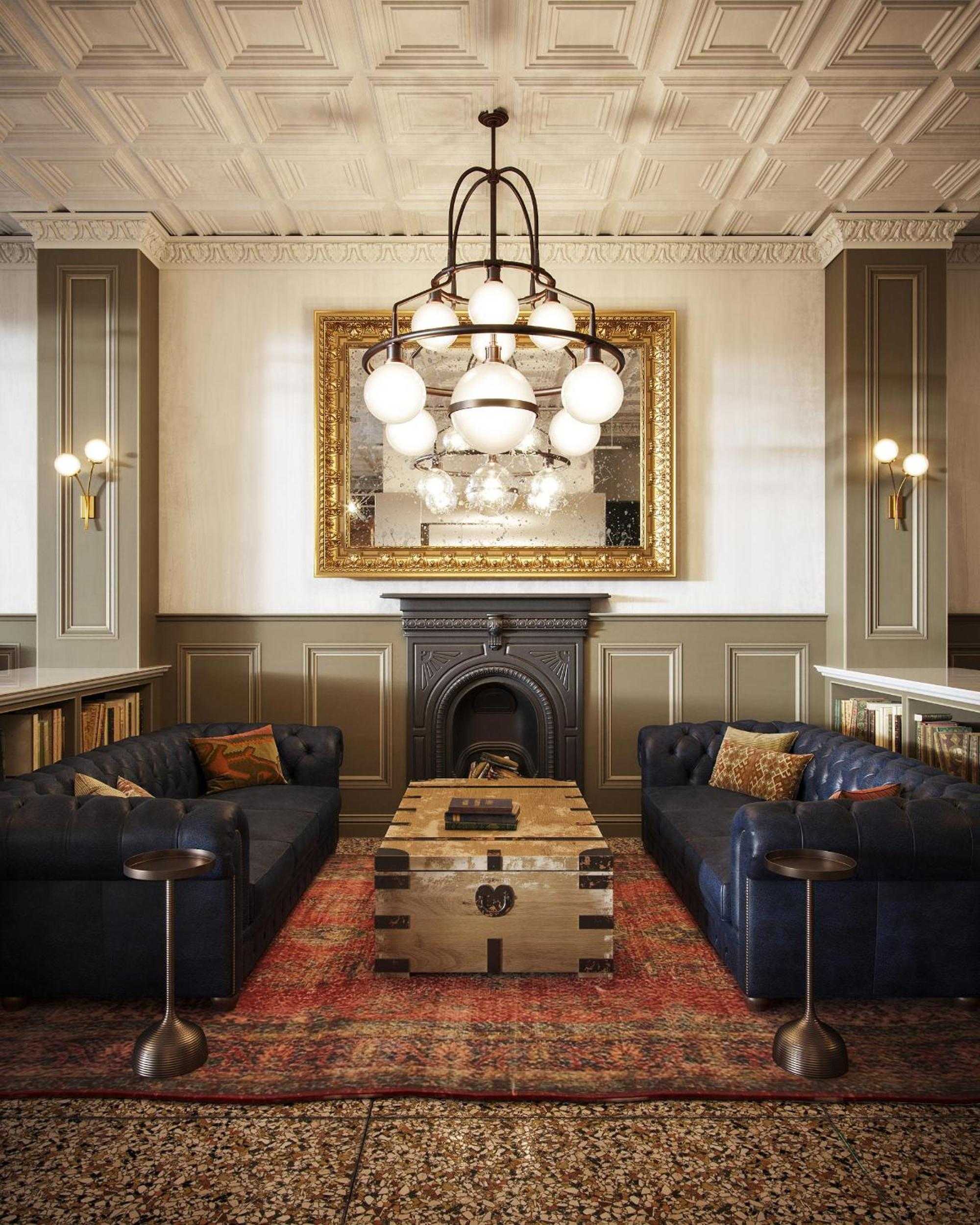 Coffered ceilings and navy leather Chesterfields create an elegant reading sanctuary, where ornate chandeliers cast warm light across Persian rugs and gilded artwork.
