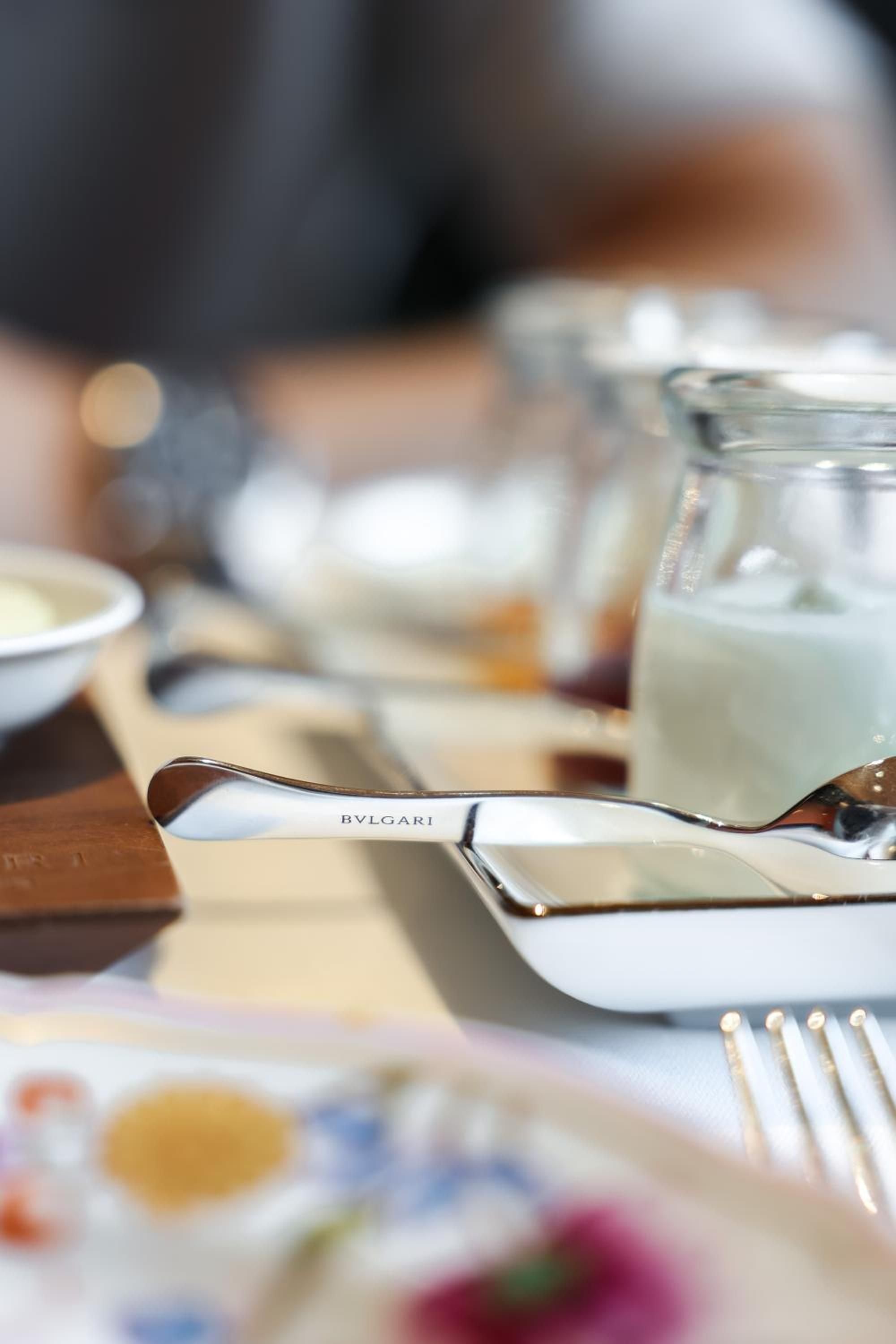 Polished Bulgari-branded cutlery catches morning light at the hotel's restaurant, where Italian precision meets Japanese attention to detail in every thoughtful touch.