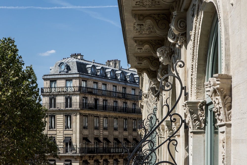 Ornate Haussmanian stonework and wrought-iron balconies frame views across classic Parisian boulevards, where centuries-old architectural details whisper stories of the city's elegant past.