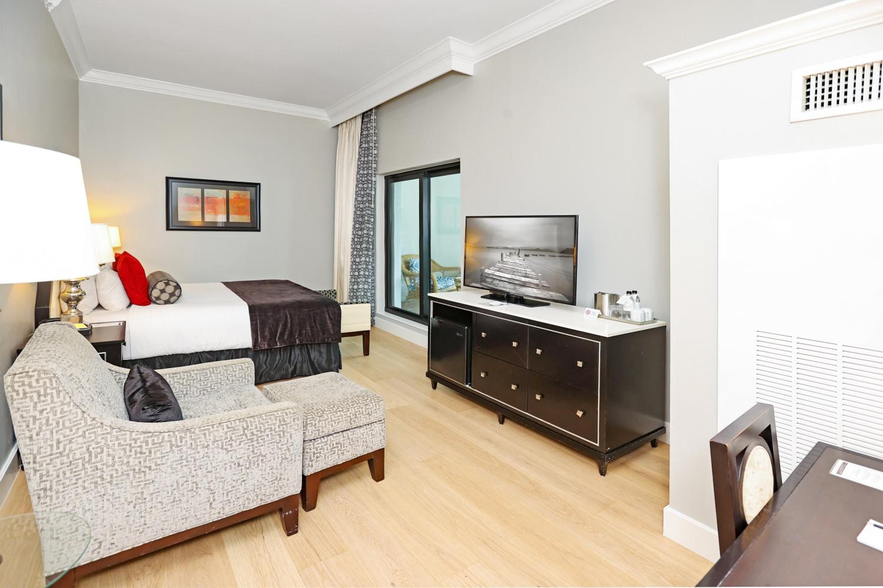 Warm hardwood floors and sophisticated neutral tones create an inviting retreat, where plush seating and thoughtful amenities blend comfort with coastal elegance.