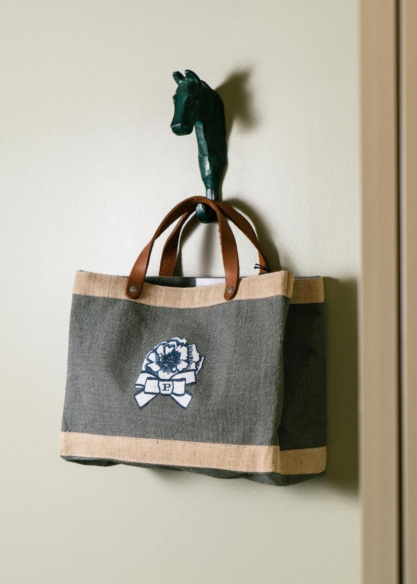 Thoughtful touches like equestrian-inspired hooks and canvas totes with floral crests reflect the property's refined residential aesthetic and Hyde Park Village's boutique charm.