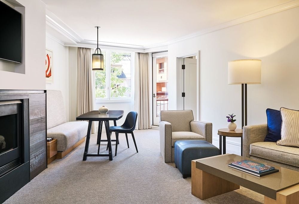 Natural light floods through floor-to-ceiling windows, illuminating plush furnishings and sleek dining nooks where mountain views become part of the décor.