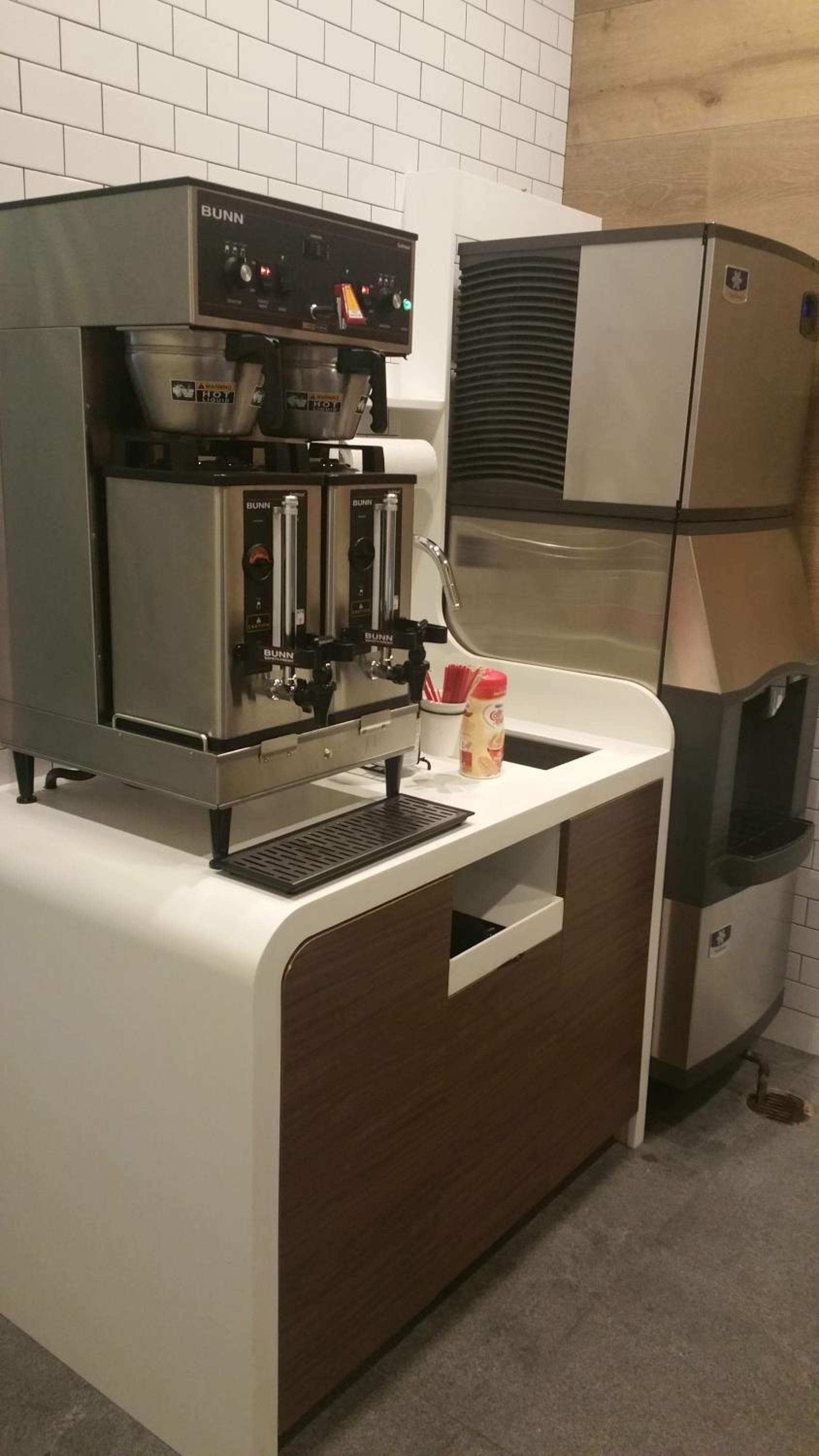Professional-grade Bunn coffee equipment and sleek ice machines create a sophisticated beverage station, reflecting the hotel's commitment to quality service and modern functionality.