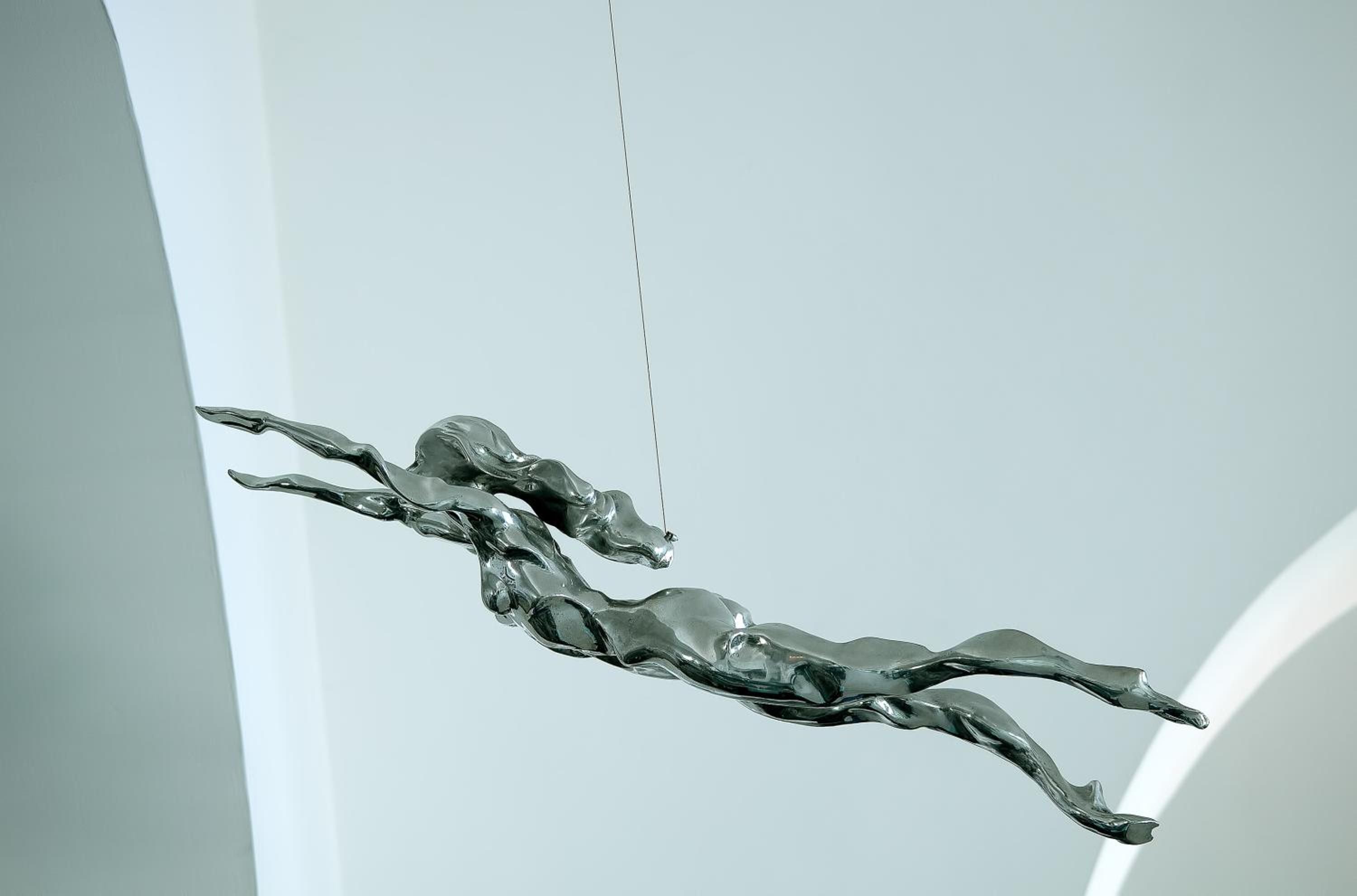 Fluid bronze sculptures dance through pristine white corridors, where contemporary artistry meets Mediterranean minimalism in this seaside sanctuary's thoughtfully curated spaces.
