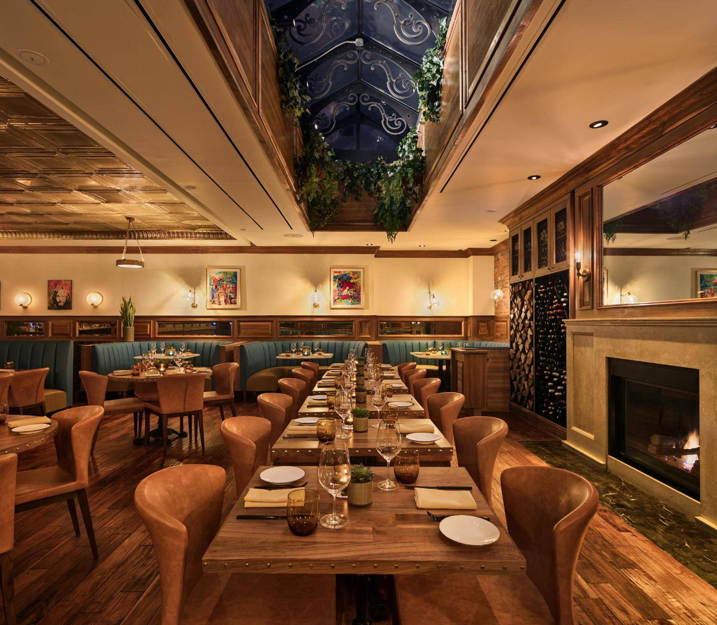 Cognac leather banquettes and exposed brick create intimate nooks beneath a dramatic skylight, where flickering candlelight transforms dinner into theater at this Greenwich Village dining destination.